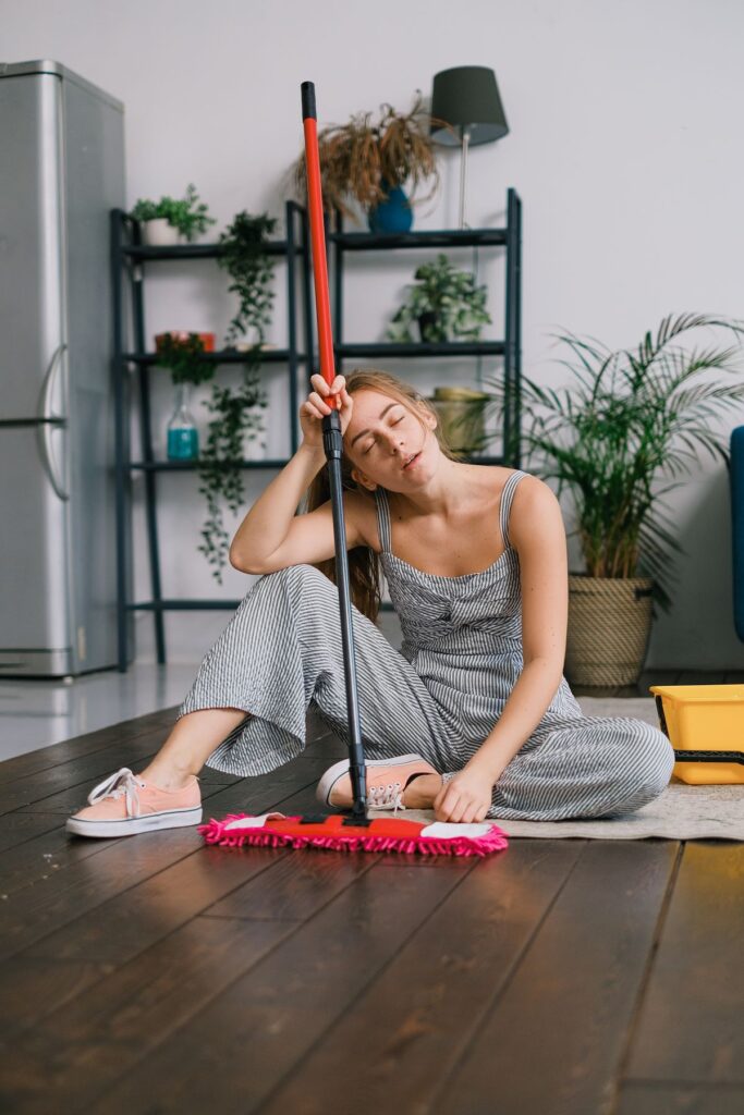 Tired woman dusting floor.